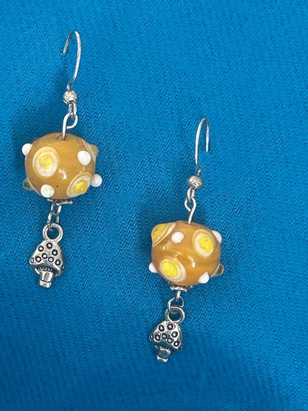 Fun and bright glass with little mushie charms. 🧚